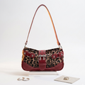 Leopard print handbag with red accents on a white background